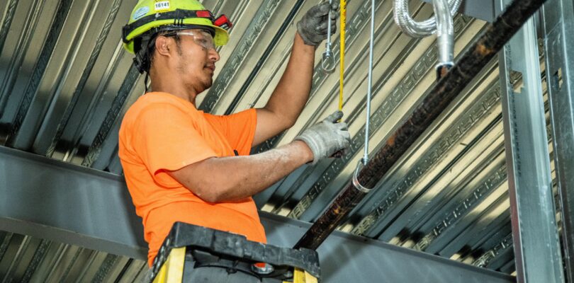 DSC 6143 1 1 Guy working on hangers updated